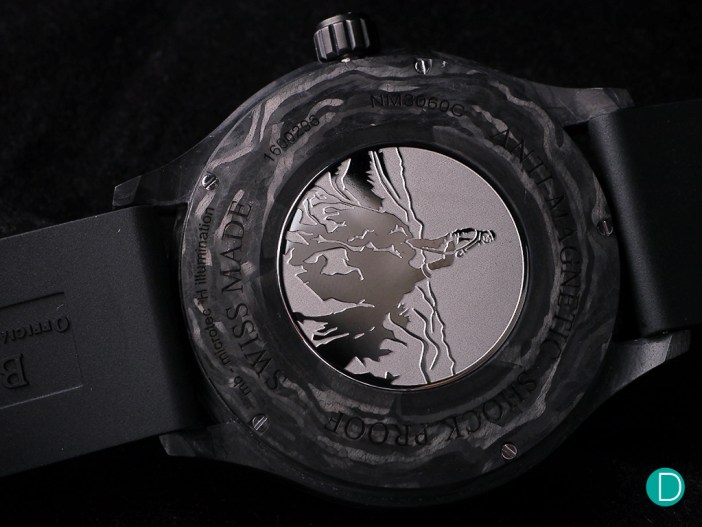 The caseback shows an engraving of a climber succeeding on a climb, straddling the peak.