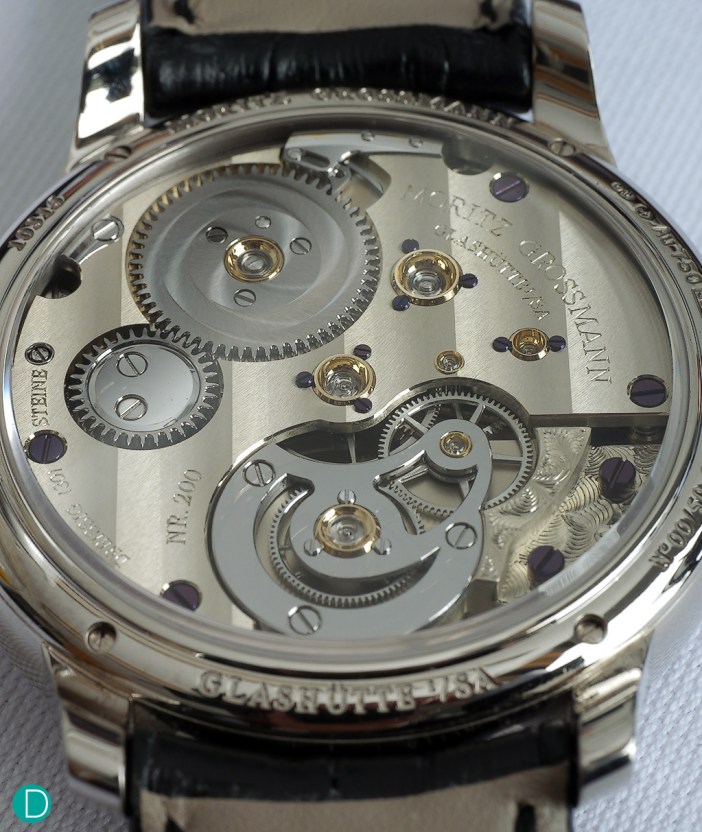 The caliber 103.0 in unfinished German Silver, but with the gear train in ultra modern ARCAP.  The movement is finished with wide Glashütte ribbing, and hand engraved details.